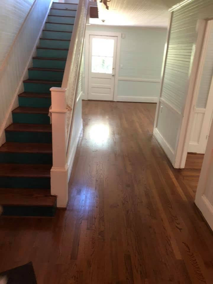 Restored hardwood entry hall and staircase in a historic home
