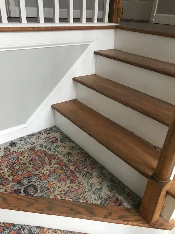 Newly installed oak stair treads with white risers and matching trim