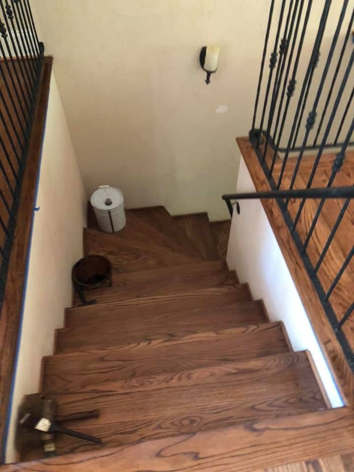 Refinished oak staircase treads and landing with iron balusters